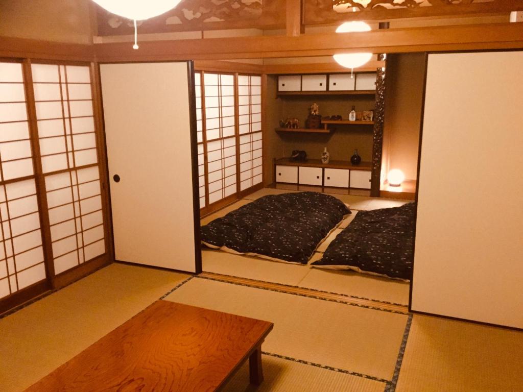 Postel nebo postele na pokoji v ubytování 島の宿 近 〜KON〜