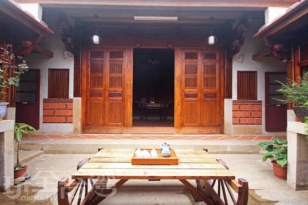 a wooden table in front of a building at Water 97 in Jincheng