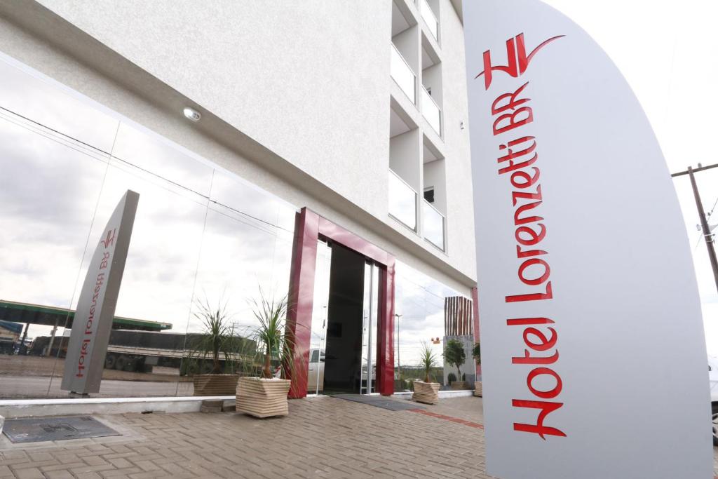 a building with a sign in front of it at Hotel Lorenzetti BR in Guarapuava