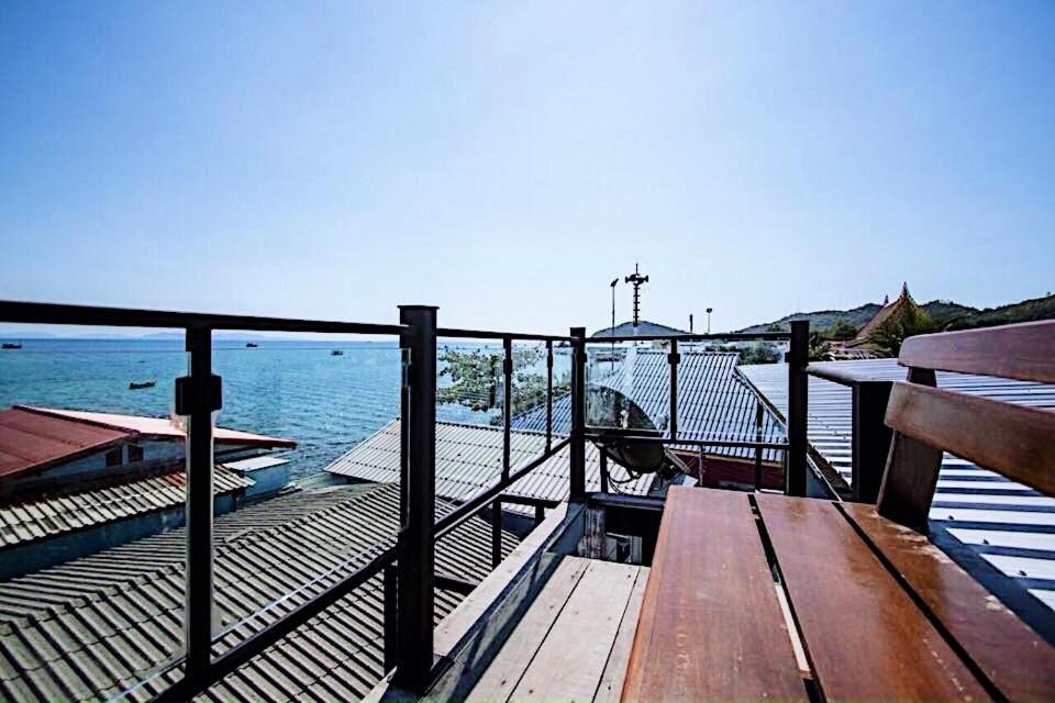 a wooden deck with a bench and the water at Chill Days @ Koh Larn in Ko Larn