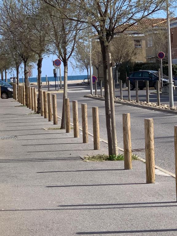 a row of trees on the side of a street at Maison de plage in Frontignan