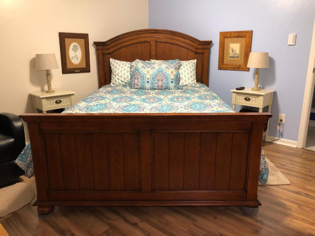 a bedroom with a large wooden bed with two night stands at Fishers Of Men Ranch Home in Marble Falls