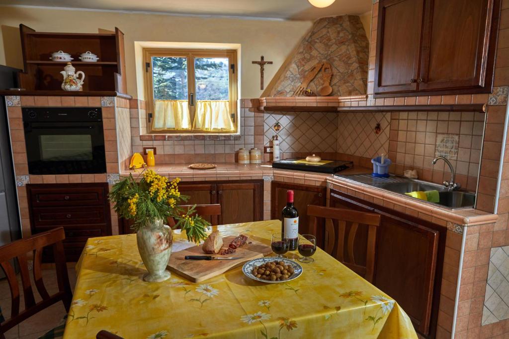 a kitchen with a table with a yellow table cloth on it at HOME sweet home Santa Caterina dello ionio in Santa Caterina dello Ionio