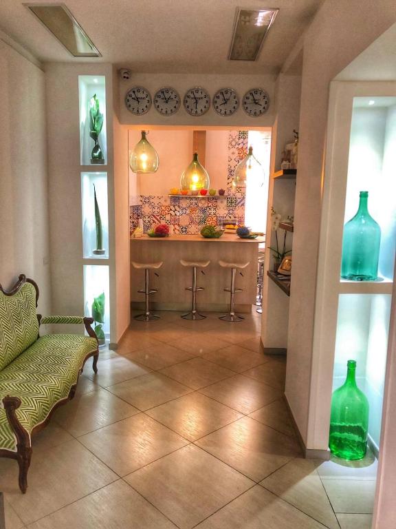 a living room with a couch and a counter with vases at Sorrento Flats in Sorrento