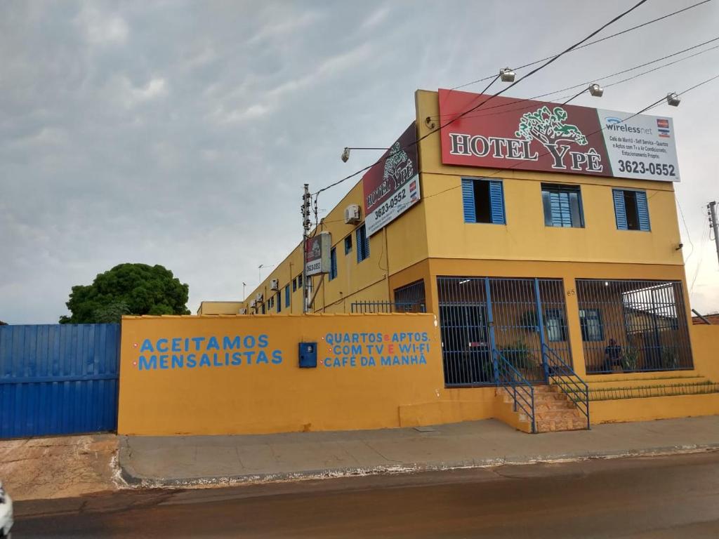un bâtiment jaune sur le côté d'une rue dans l'établissement Hotel Ypê, à Rio Verde