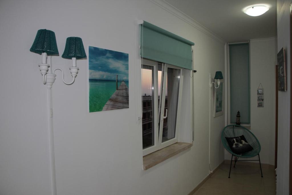 a room with two pictures on the wall and a window at Ericeira Sunset Apartment in Ericeira