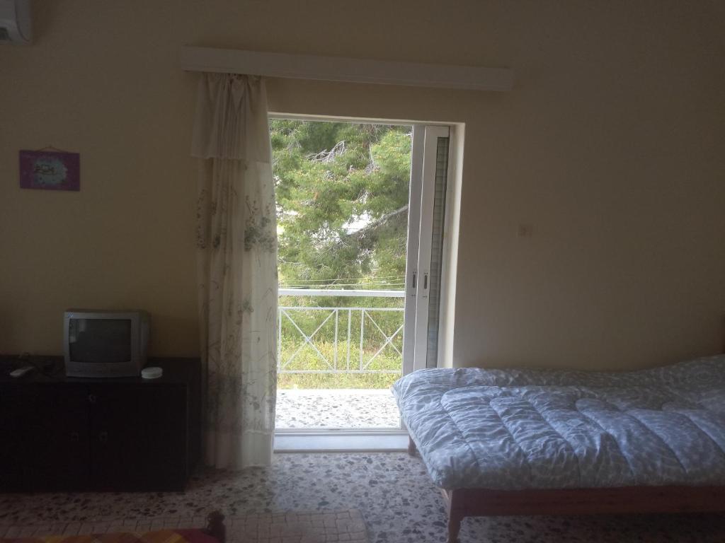 Ένα ή περισσότερα κρεβάτια σε δωμάτιο στο Vangelis House near Athens Airport