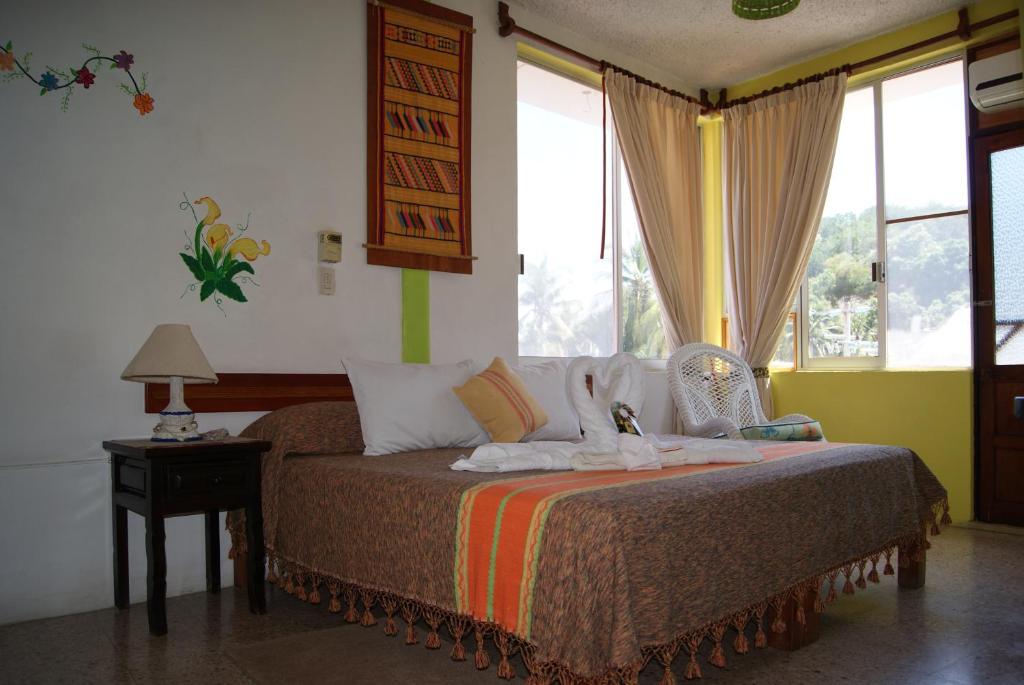 מיטה או מיטות בחדר ב-Hotel La Cabaña