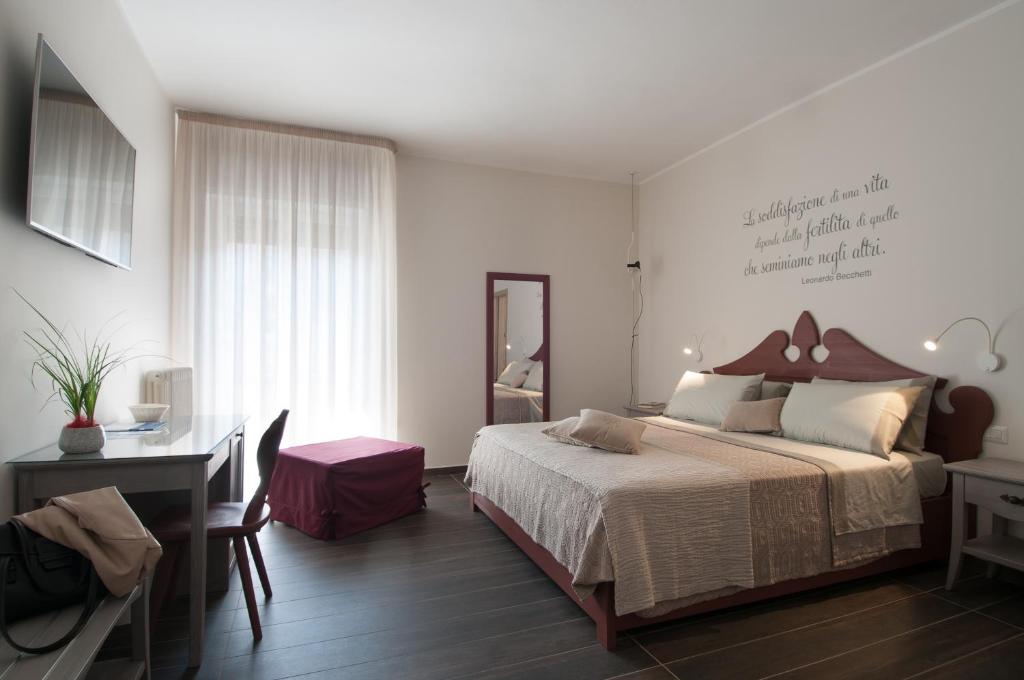 1 dormitorio con cama, escritorio y escritorio en KissfromSalento B&B+Bike, en Lecce