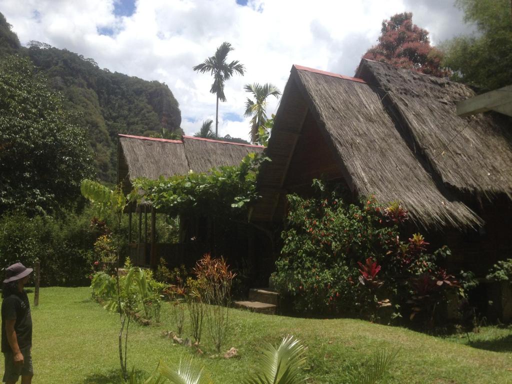 a man standing in front of a house at Orau Inn in Sarilamak