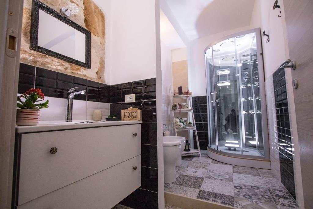 a bathroom with a toilet and a sink and a shower at La Maison d'Irene in Avola