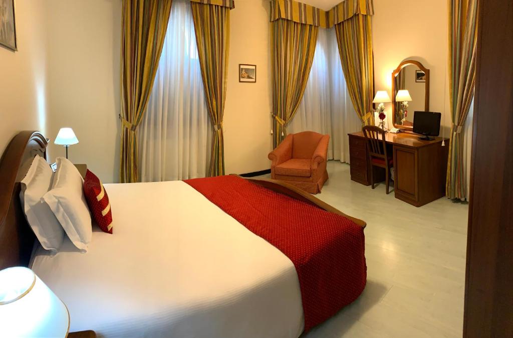 Postel nebo postele na pokoji v ubytování Albergo Italia