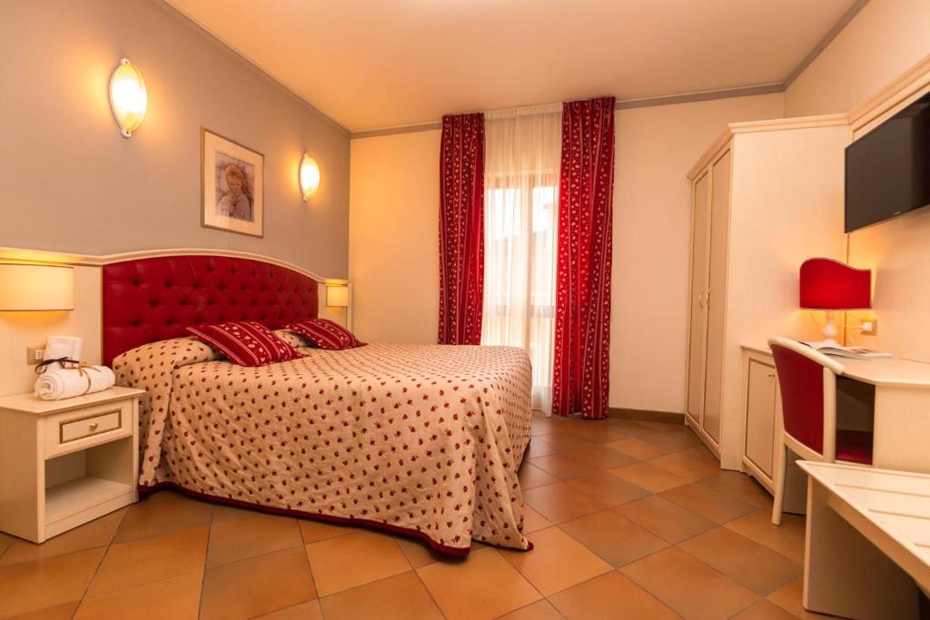 Postel nebo postele na pokoji v ubytování Hotel Le Mura