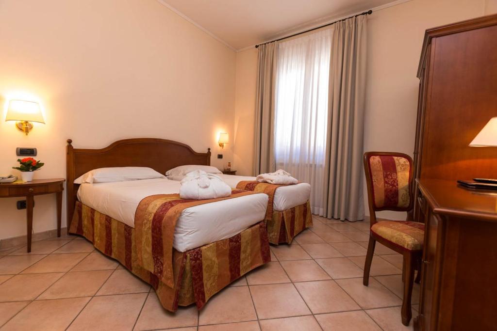 Postel nebo postele na pokoji v ubytování Hotel Le Mura