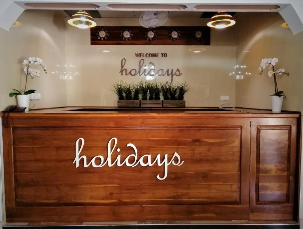 a counter with a sign that says holidays holidays at holidays hotel in Dummaladeniya East