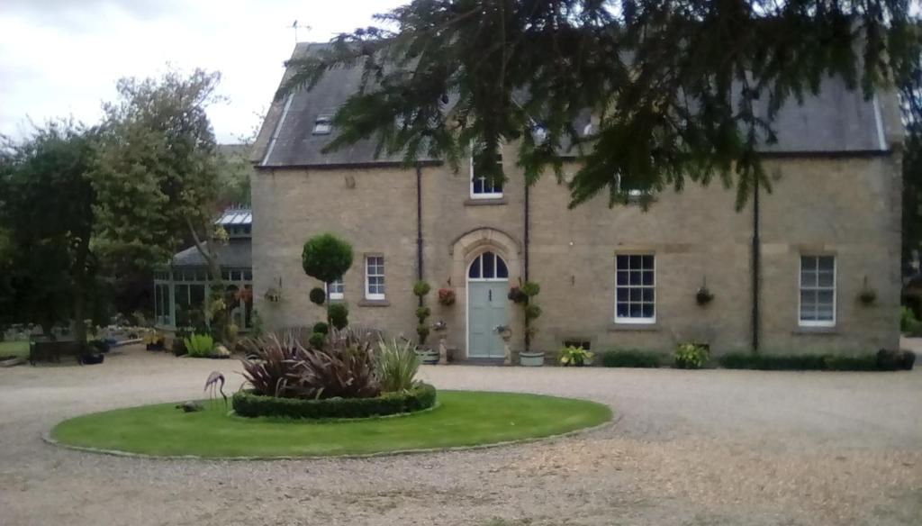 a large stone house with a large driveway at Westgate Manor in Westgate