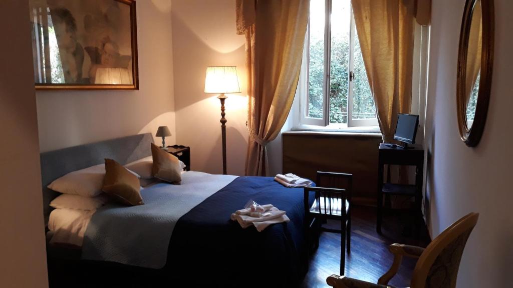 a bedroom with a bed and a window at Florian in La Spezia