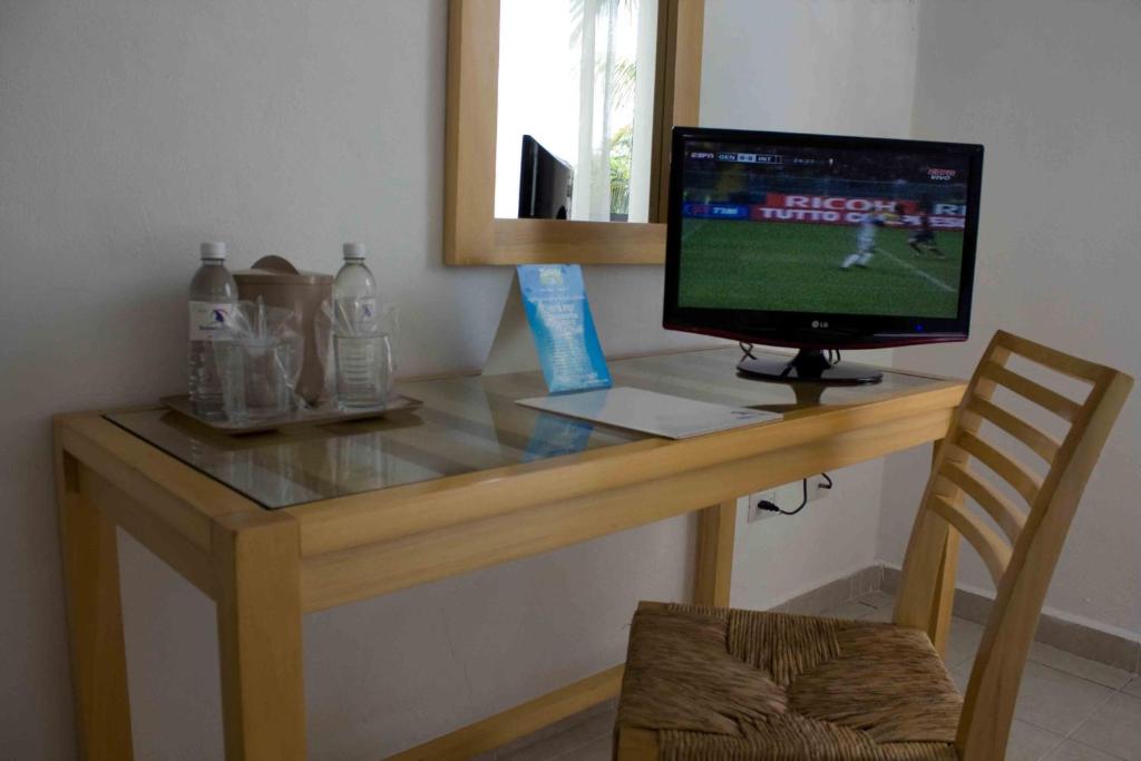 TV a/nebo společenská místnost v ubytování Sotavento Hotel & Yacht Club