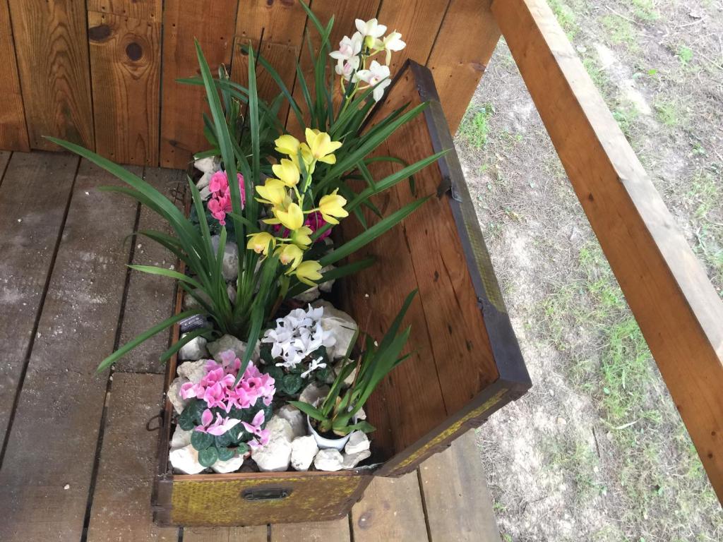a wooden box with flowers and rocks in it at Quinta do Meco - Beach & Nature in Aldeia do Meco