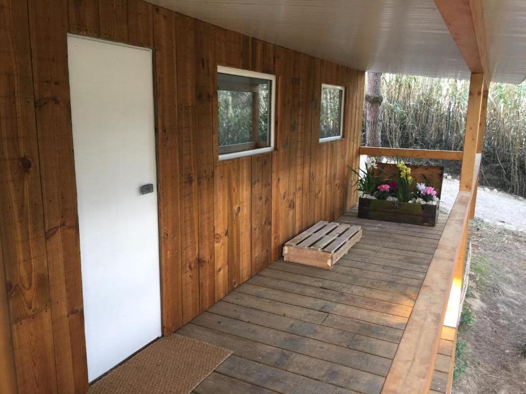 a porch of a cabin with a door and a window at Quinta do Meco - Beach & Nature in Aldeia do Meco