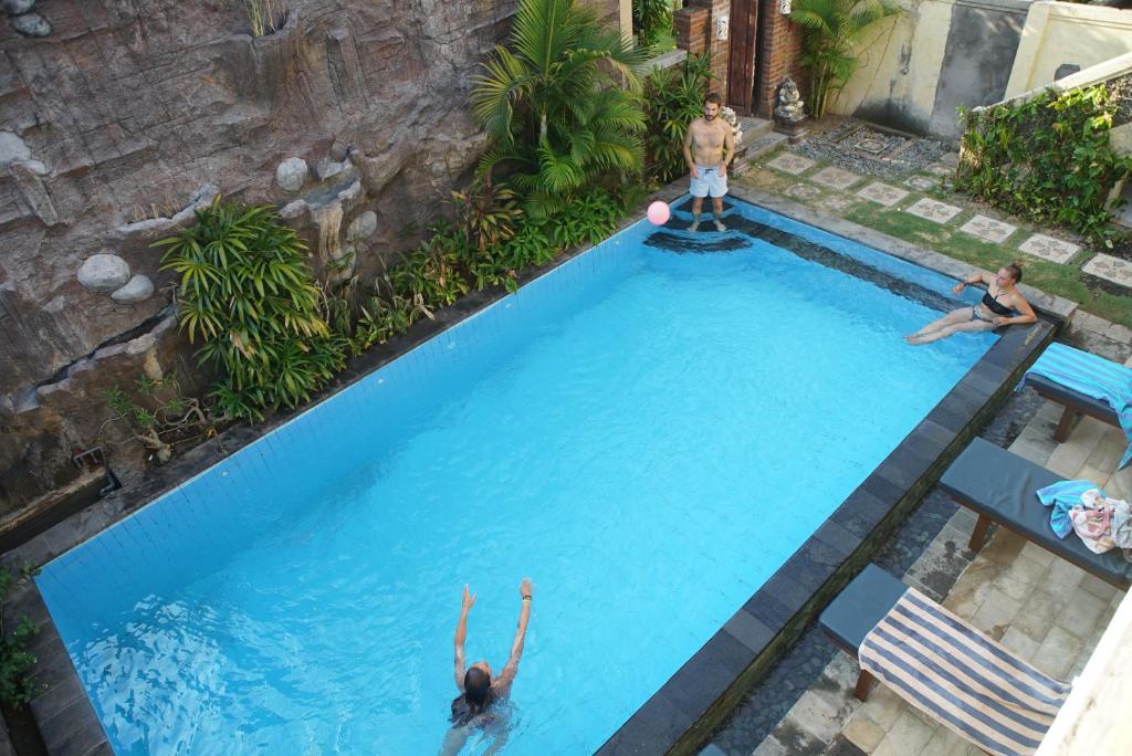 two people playing in a swimming pool at Oma In Pemuteran Bali in Pemuteran