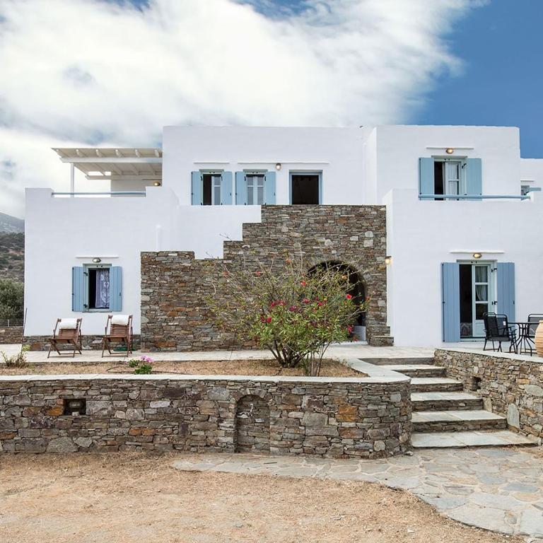a white house with a stone wall and stairs at Villa Filitsa in Platis Gialos