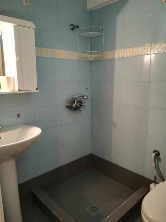 a bathroom with a sink and a toilet at Serifos Palace in Livadakia
