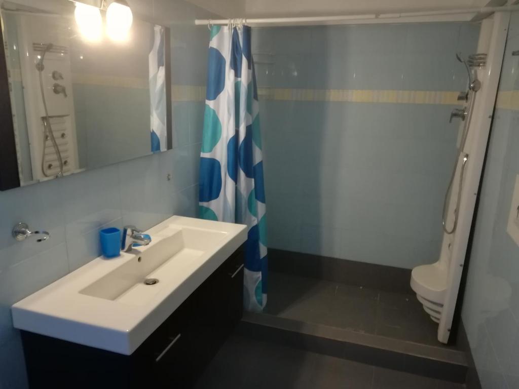 a bathroom with a sink and a shower and a toilet at Serifos Palace in Livadakia
