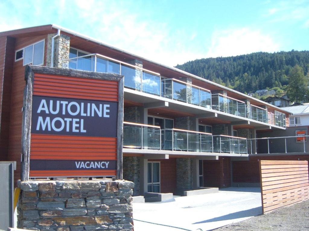 a building with a motel sign in front of it at Autoline Queenstown Motel in Queenstown