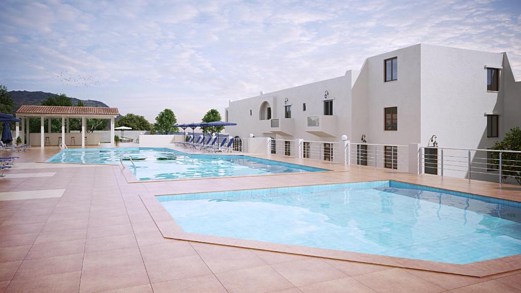 a large swimming pool next to a building at Dimitra Hotel in Hersonissos