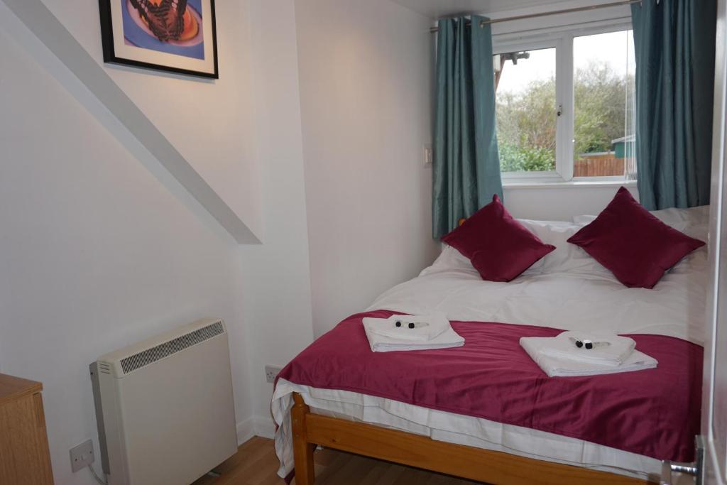 a bedroom with a bed with two towels on it at Grange Apartment in Bristol