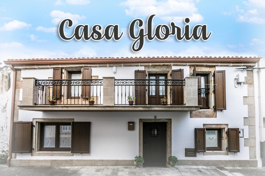 a building with a balcony and the words casa gloria at Casa Gloria in Camariñas