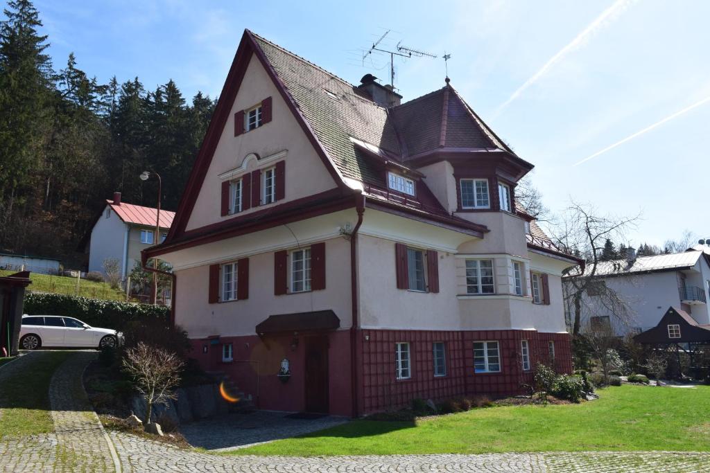 a large red and white house with at George Pension in Mariánské Lázně