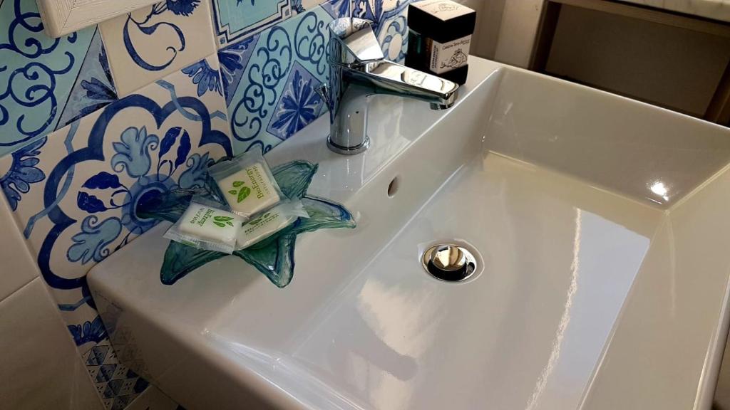 a white sink with a book on top of it at Nereide in Tropea