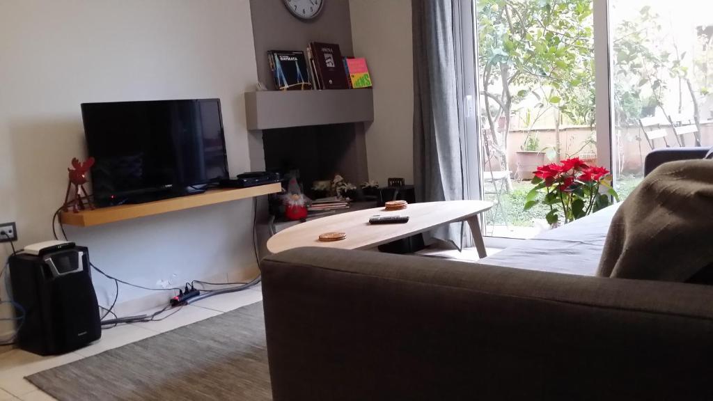 A television and/or entertainment centre at Athenian apartment with garden, near metro station Chalandri Nu 3