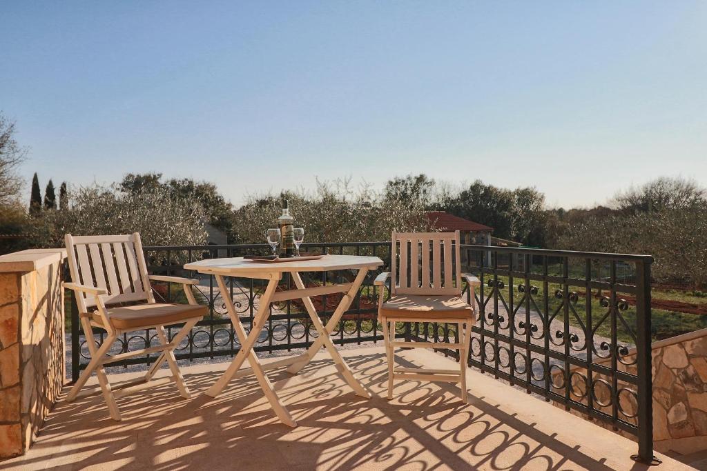 a wooden table and two chairs on a balcony at Casa Vesna in Rovinj