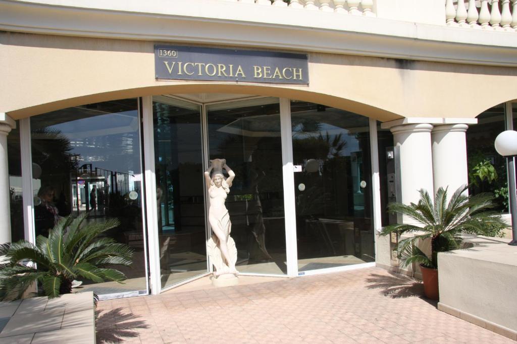 a mannequin is standing in the doorway of a building at Sharon Apartment in Victoria Beach in Menton