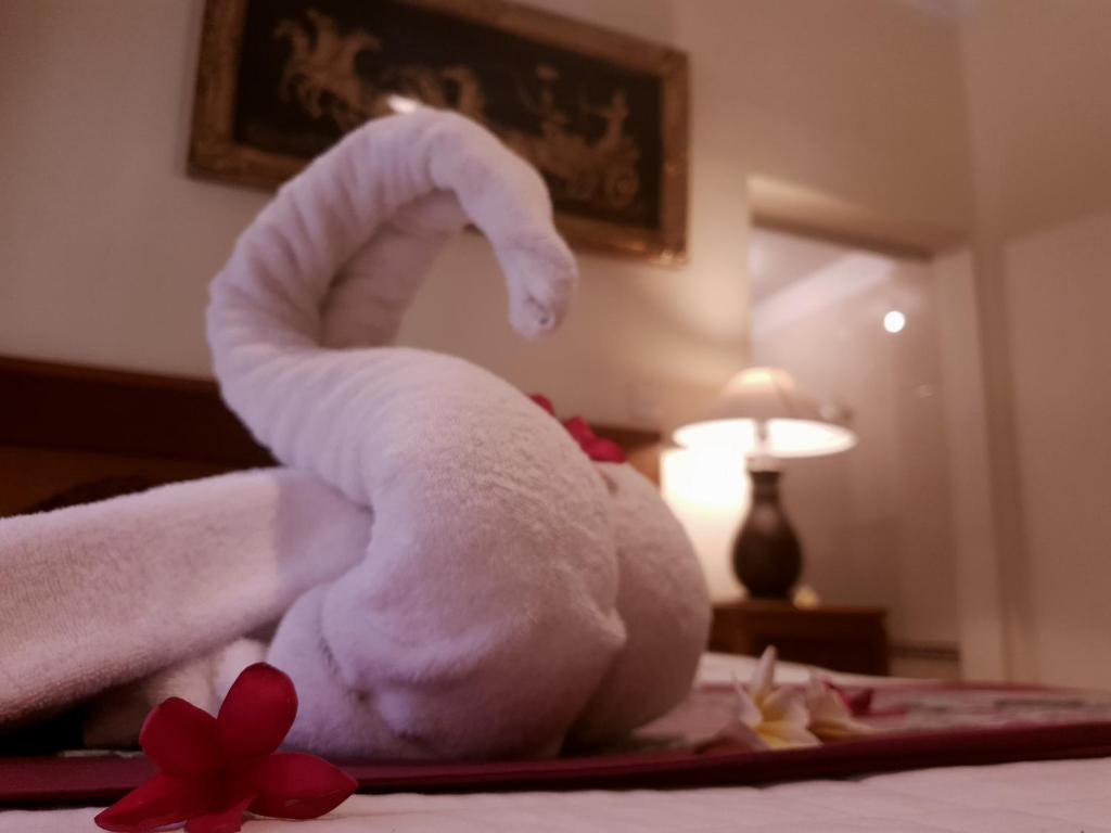 a towel animal sitting on top of a bed at Bale Bali House in Ubud