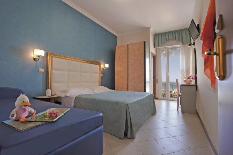Postel nebo postele na pokoji v ubytování Hotel Helios