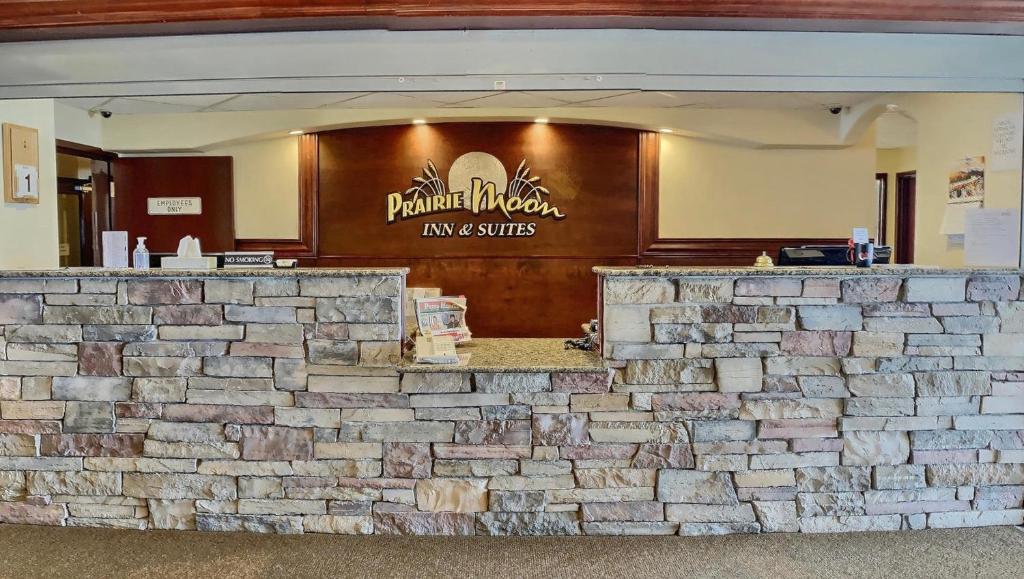 a stone wall in front of a restaurant at Prairie Moon Inn & Suites Unity in Unity