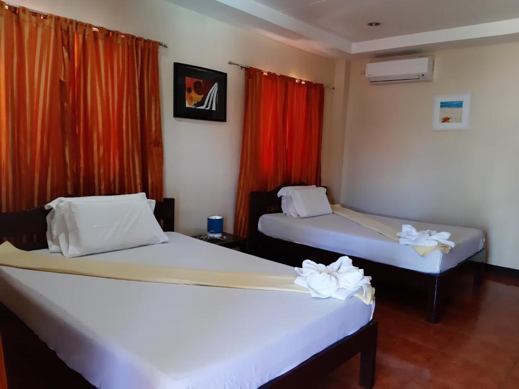 Letto o letti in una camera di SLAM'S Garden Dive Resort