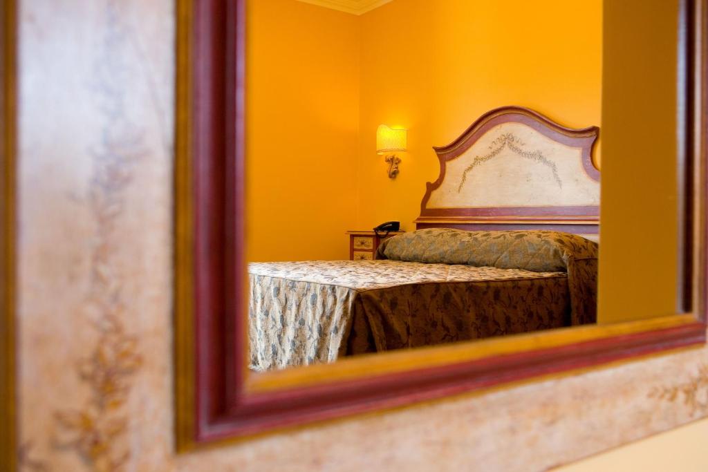 Postel nebo postele na pokoji v ubytování Hotel Palazzo Guardati