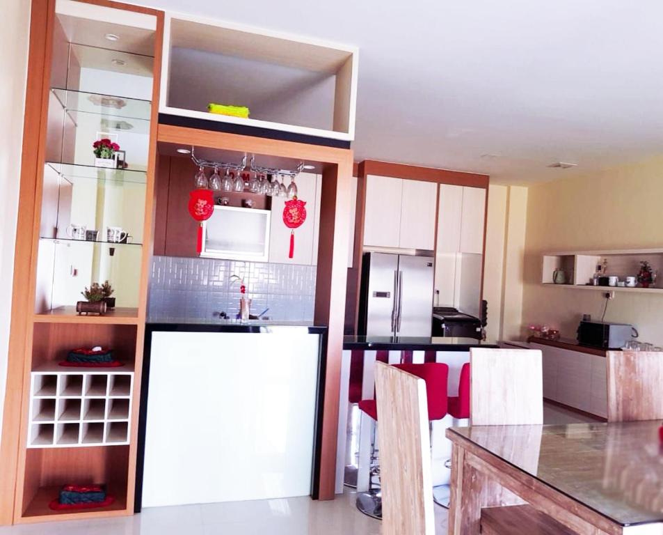 a kitchen with white cabinets and a counter top at Jakson Homestay in Batam Center