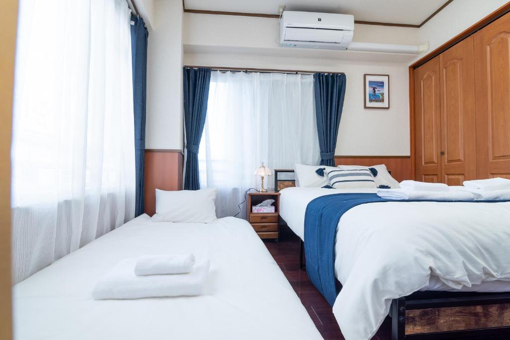 Postel nebo postele na pokoji v ubytování Uhome Iriya Apartment