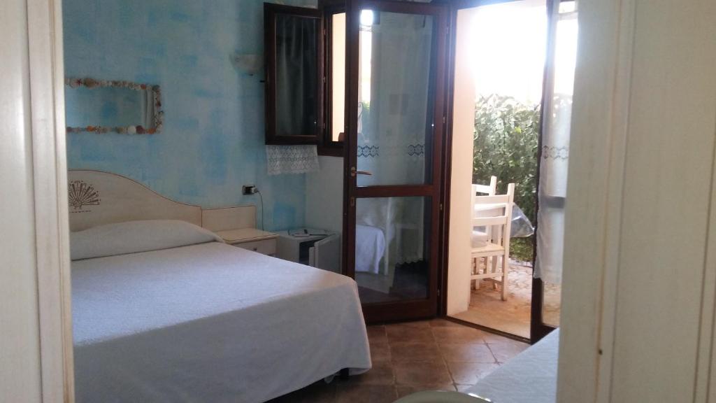 Postel nebo postele na pokoji v ubytování Hotel Sa Cralla Villasimius