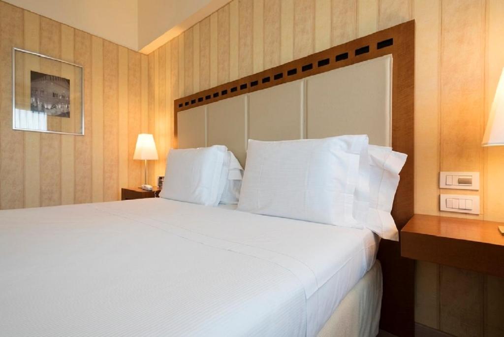 Postel nebo postele na pokoji v ubytování Hotel Maggior Consiglio