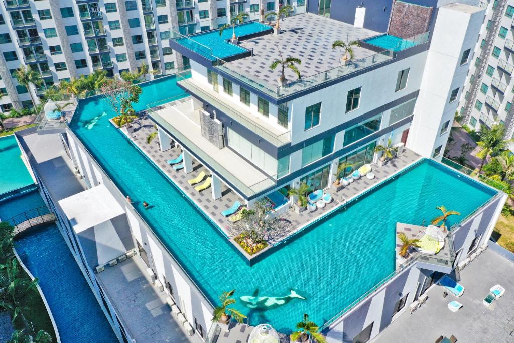 an aerial view of a building with a swimming pool at Arcadia Beach Resort Pattaya in Pattaya South