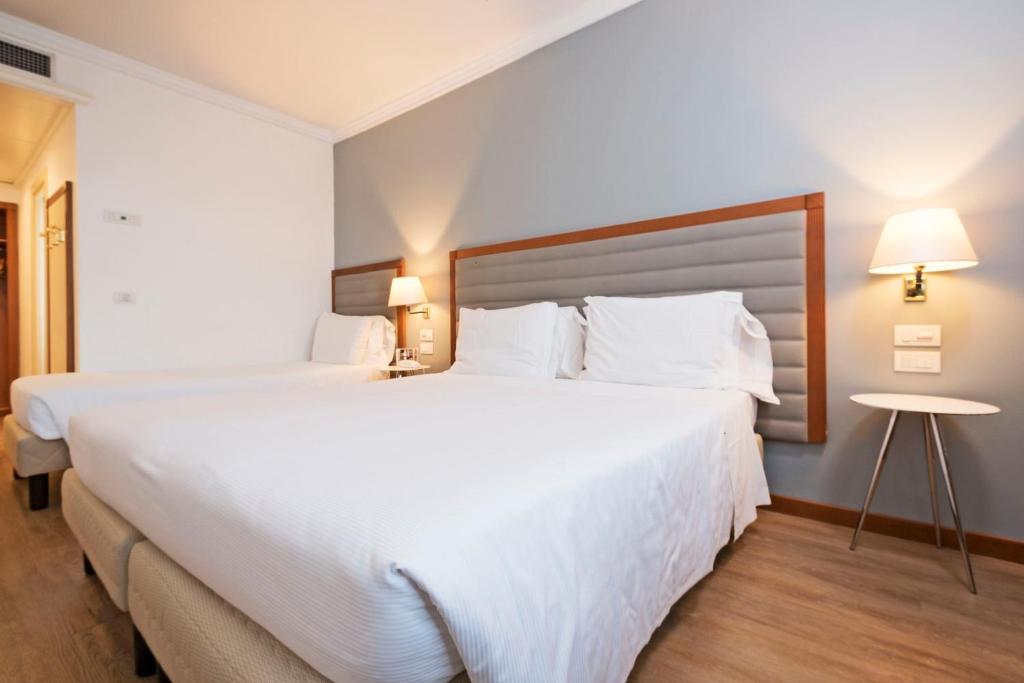 Postel nebo postele na pokoji v ubytování Hotel Maggior Consiglio