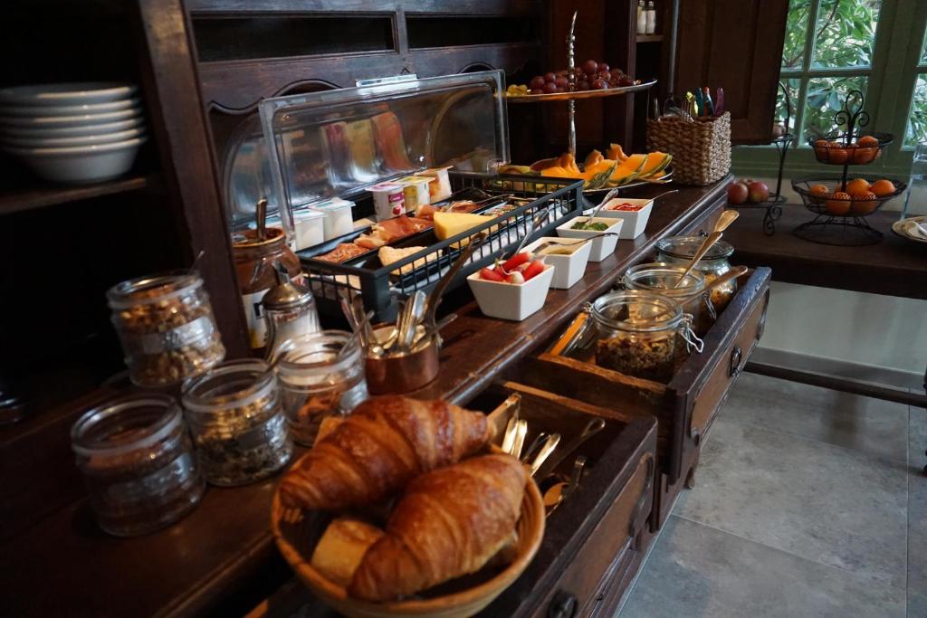 a breakfast buffet with croissants and other breakfast foods at Hotel Le Ponteil in Antibes
