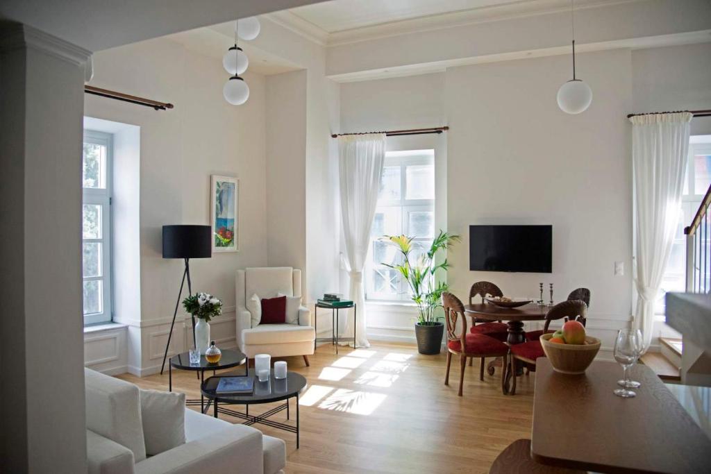 a living room with a couch and a table at Four Streets Athens - Luxury Suites Apartments in Athens in Athens